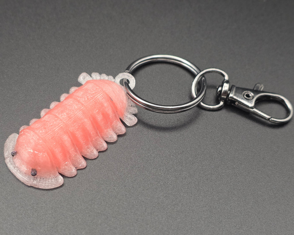 Pink keychain with a metal ring on a gray background