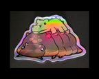 Holographic sticker of a Cartoon crocodillio isopod with a crodile stuffed animal on top 