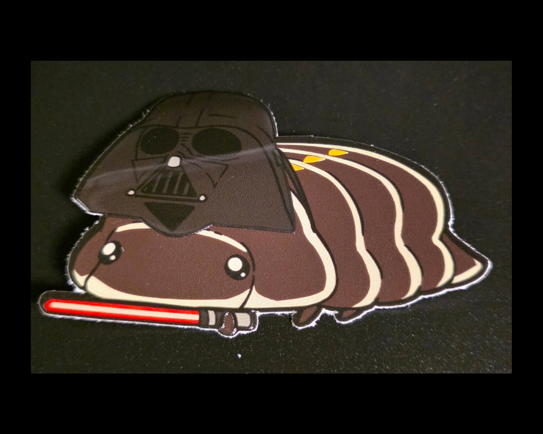 Cartoon darth vader isopod wearing a Darth Vader helmet with a lightsaber on a black background