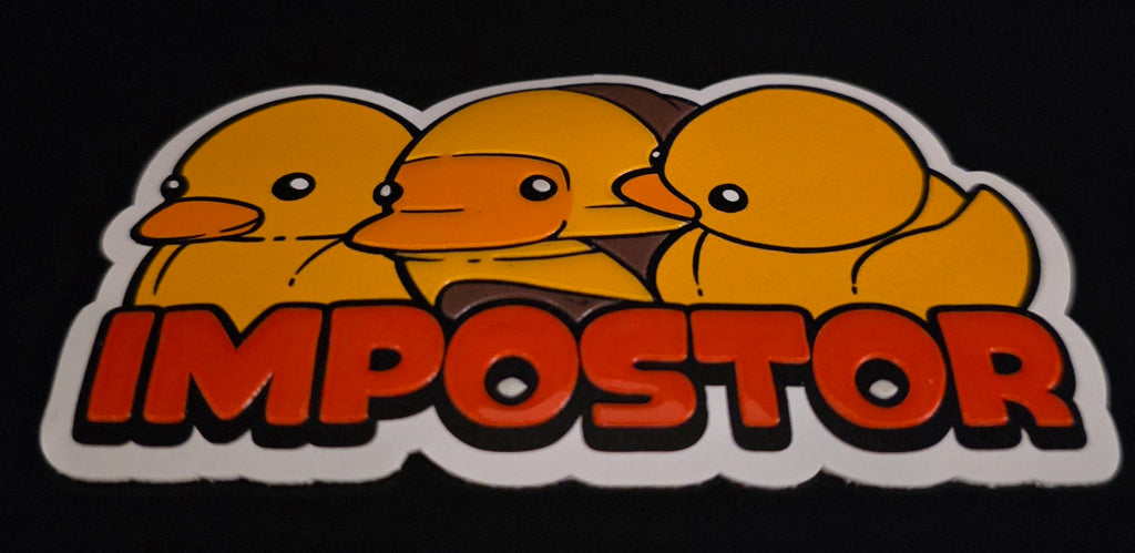 Sticker with three yellow ducks and the word 'IMPOSTOR' on a black background