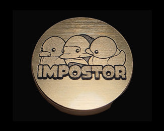 An brass circle with a rubber ducky isopod and two rubber ducks on each side of it