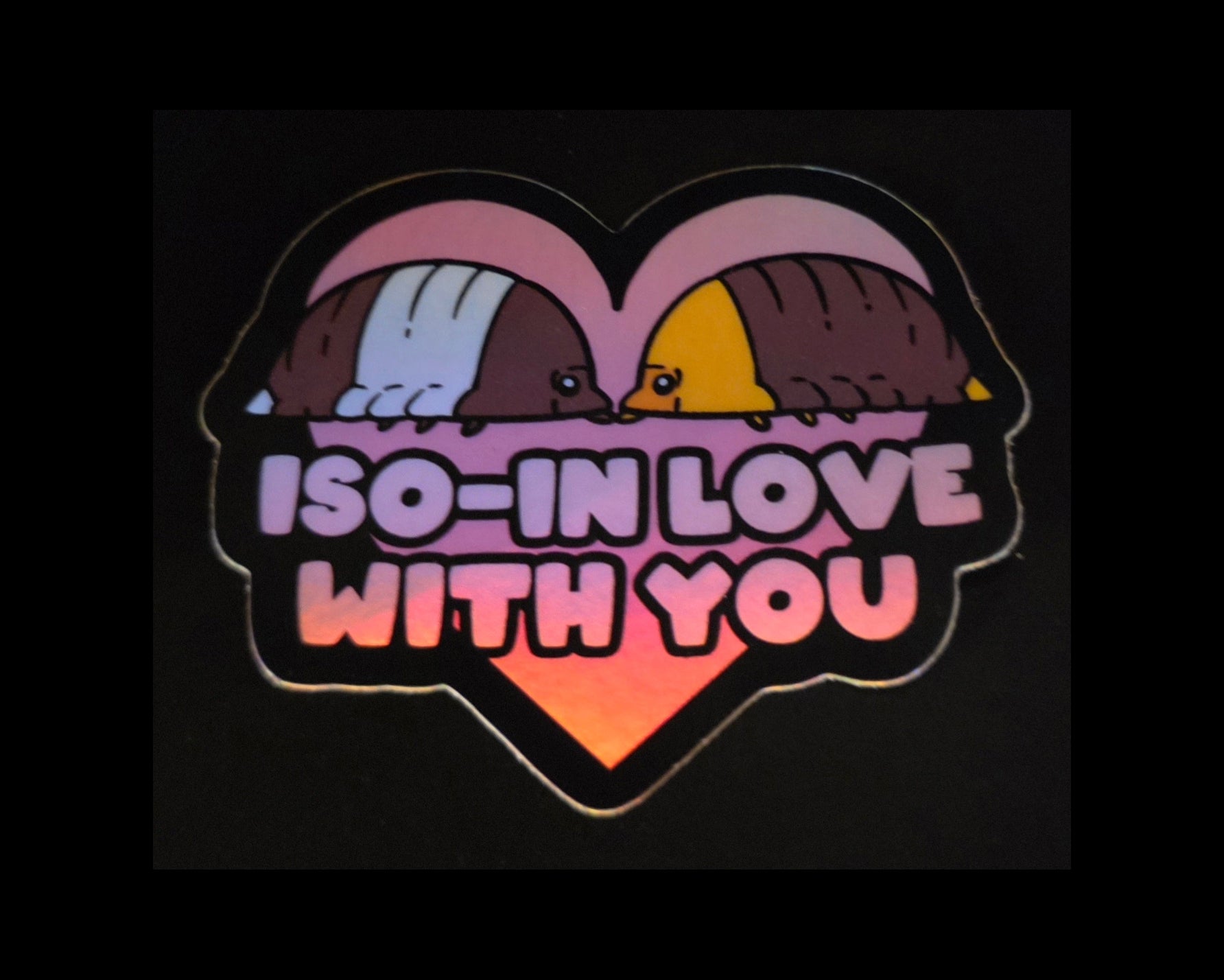 A holographic sticker of a panda and a ducky isopod in a heart with 'ISO-IN LOVE WITH YOU' text on a black background