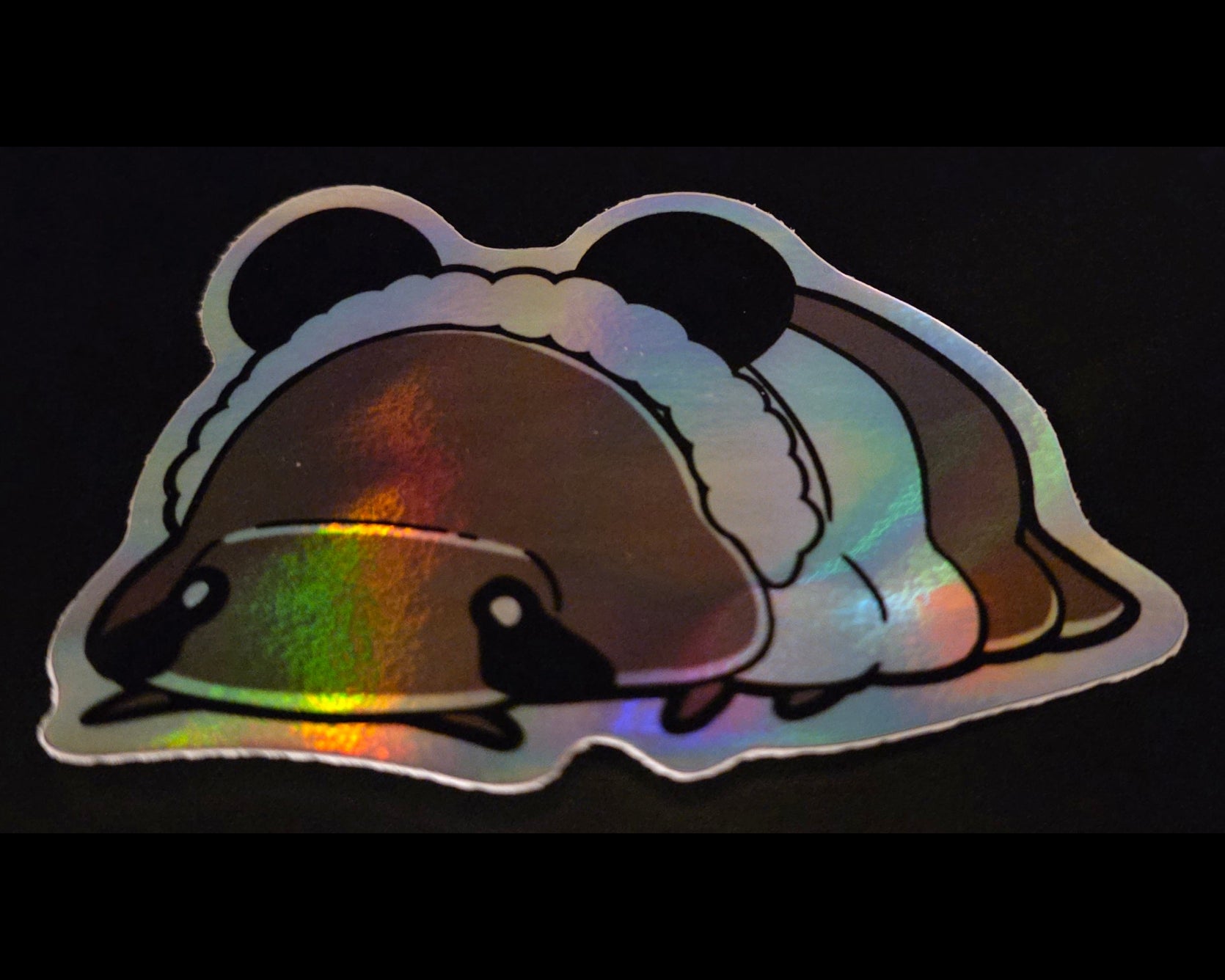 Holographic panda king isopod ticker on a black background