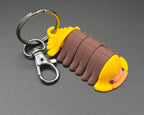 Keychain with a brown and yellow design on a gray background
